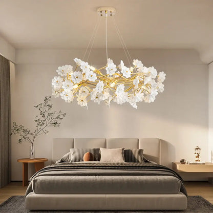 Elegant french white flower chandelier with gold-toned metal branches in white ceramic for romantic home décor