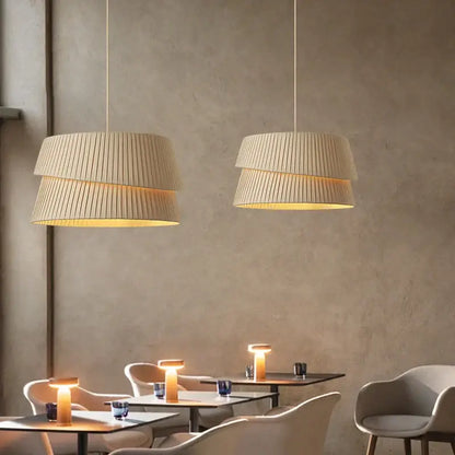Beige pleated tiered pendant lights with warm glowing interiors in decorbites french cream chandelier fabric lamps