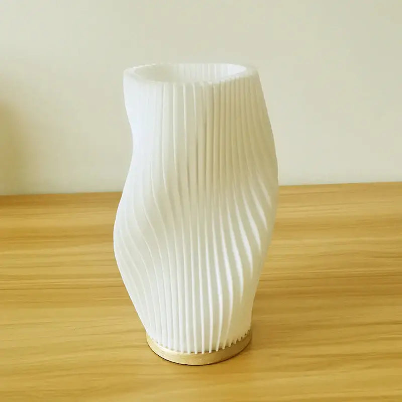 White pleated vase with gold-toned circular base complementing decorbites french cream style 3d desk lamp