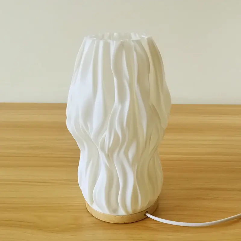 White ceramic desk lamp with wavy texture and wooden base in french cream style for bedside or study use