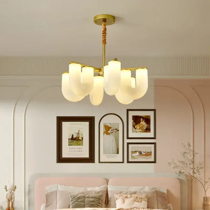 Gold-toned modern chandelier with frosted glass shades complementing decorbites french cream floor lamp design