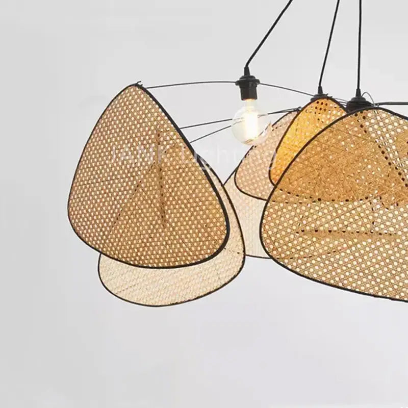 Modern triangular pendant lights featuring woven rattan shades and black metal frames in a french design rattan chandelier