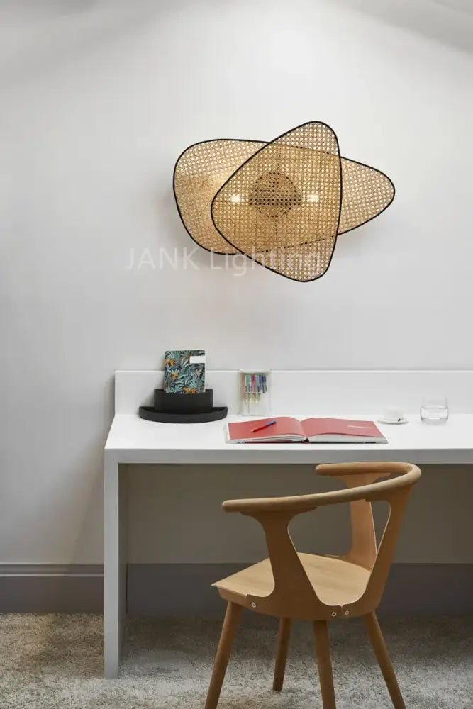 Woven rattan wall sconce with modern abstract design in decorbites french design rattan chandelier for home lighting french design market