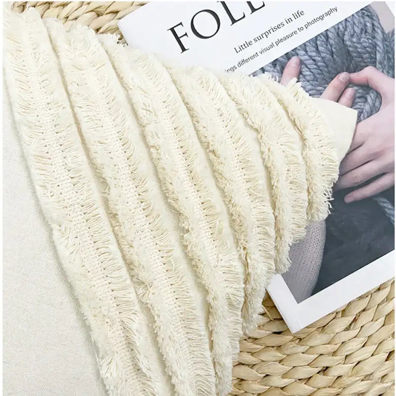 Cream-colored frayed-edge woven fabric trim with textured rustic appearance on decorbites fringed geometry cushion cover