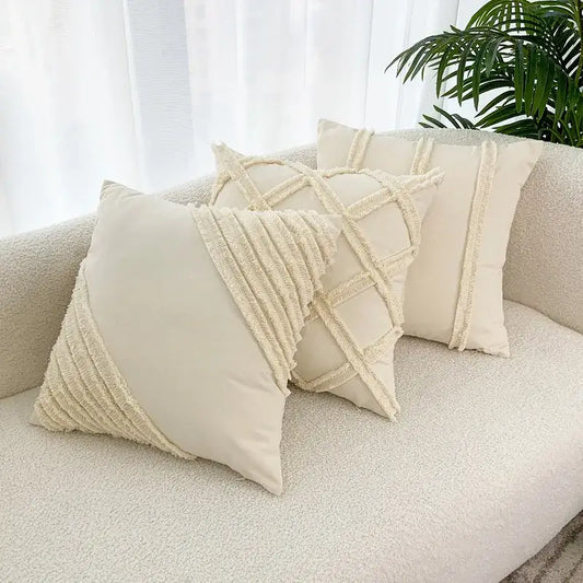 Cream-colored throw pillows with textured woven fringe detailing from decorbites fringed geometry collection for living room use