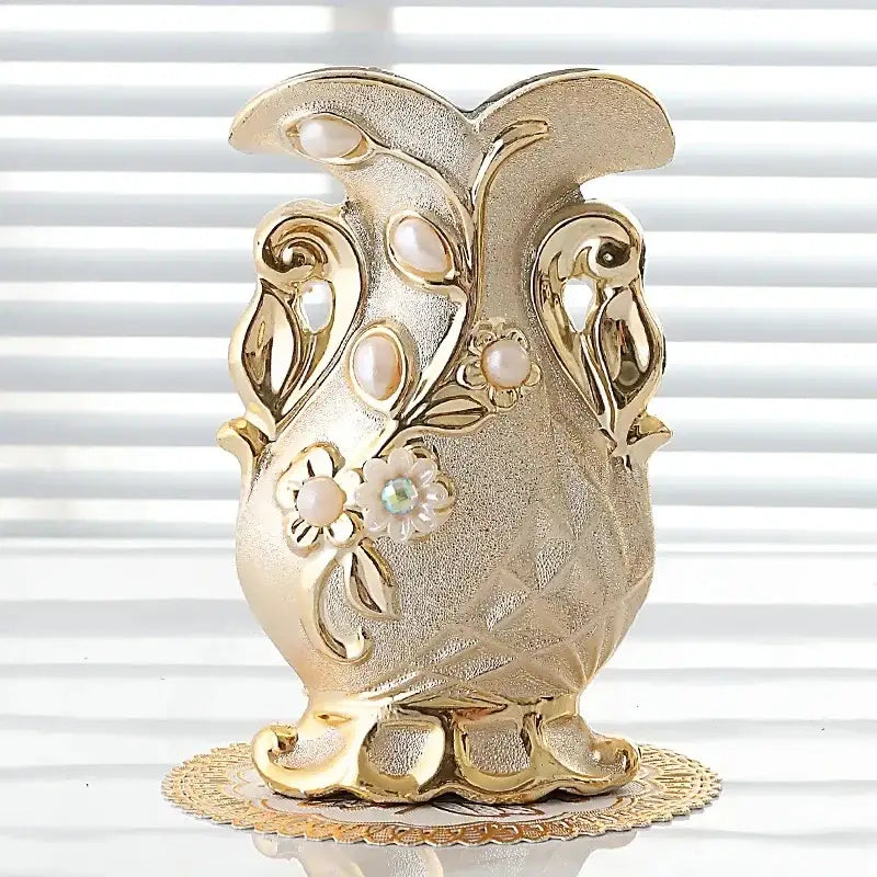 Gold-colored frosted porcelain flower vase with ornate floral designs and gemstone accent for elegant home decor