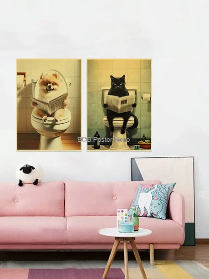 Two framed vintage-style animal bathroom posters featuring a pomeranian and black cat reading newspapers above a pink sofa