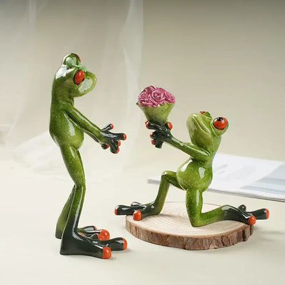 Green ceramic frog figurine with red eyes and orange toes kneeling on wooden slice offering pink rose bouquet decorbites funny frog couple resin decor