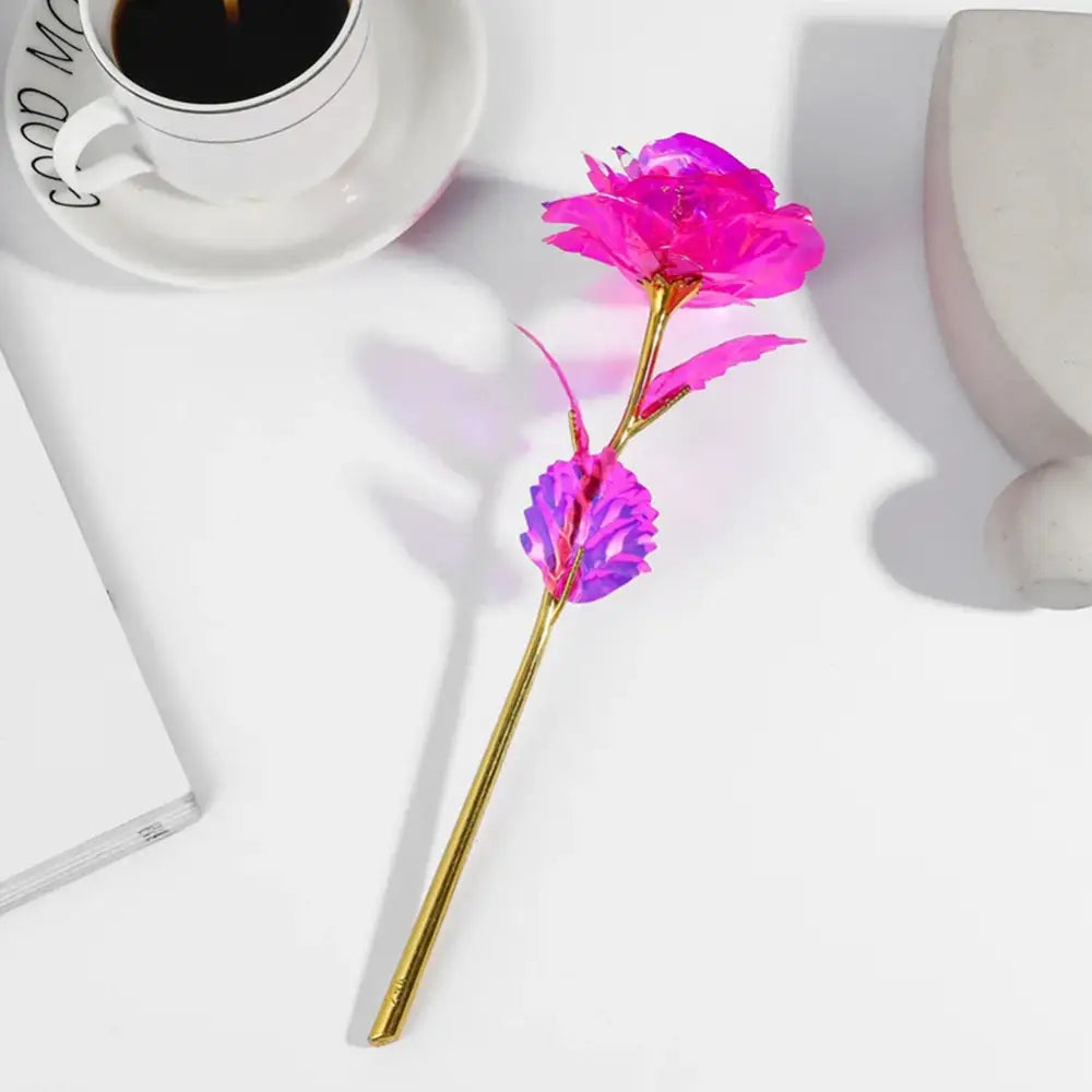A decorbites galaxy rose ornamental keepsake featuring a vibrant pink and purple metallic rose with a gold stem