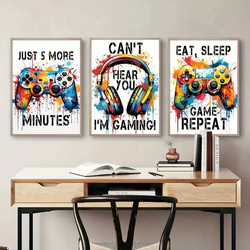 Three framed DecorBites™ graffiti gamepad posters with vibrant splattered paint for stylish gamer room decor