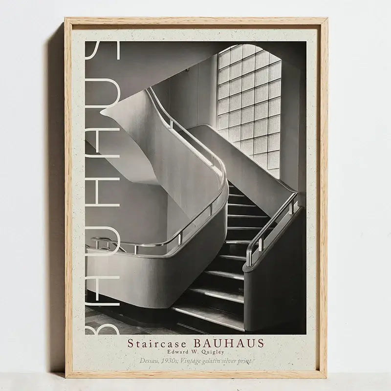 A framed black and white geometric bauhaus abstract canvas wall art featuring modernist staircase and vertical bauhaus lettering