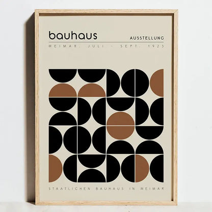 Minimalist framed poster featuring geometric bauhaus abstract black and tan circles with bauhaus text on off-white background