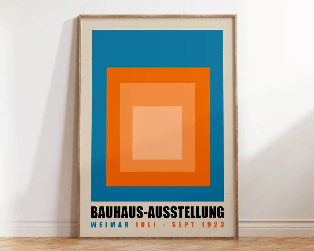 A framed bauhaus canvas poster with blue orange and peach concentric squares and bold black text for modern decor