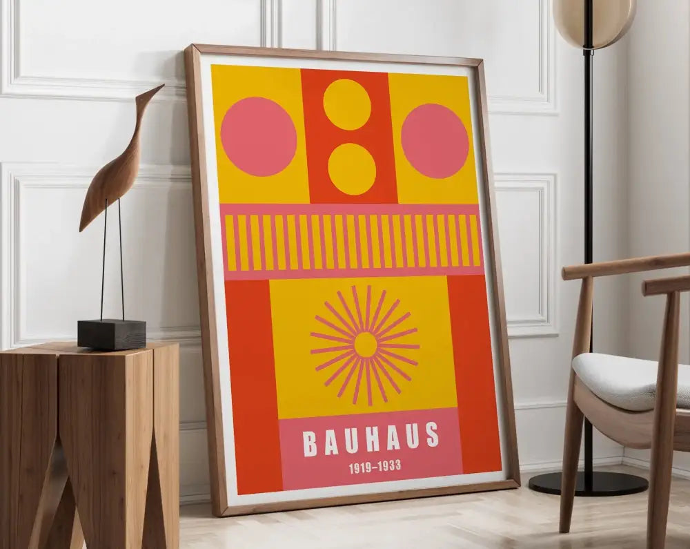 A vibrant bauhaus canvas poster featuring bold pink and yellow circles on orange background in a wooden frame