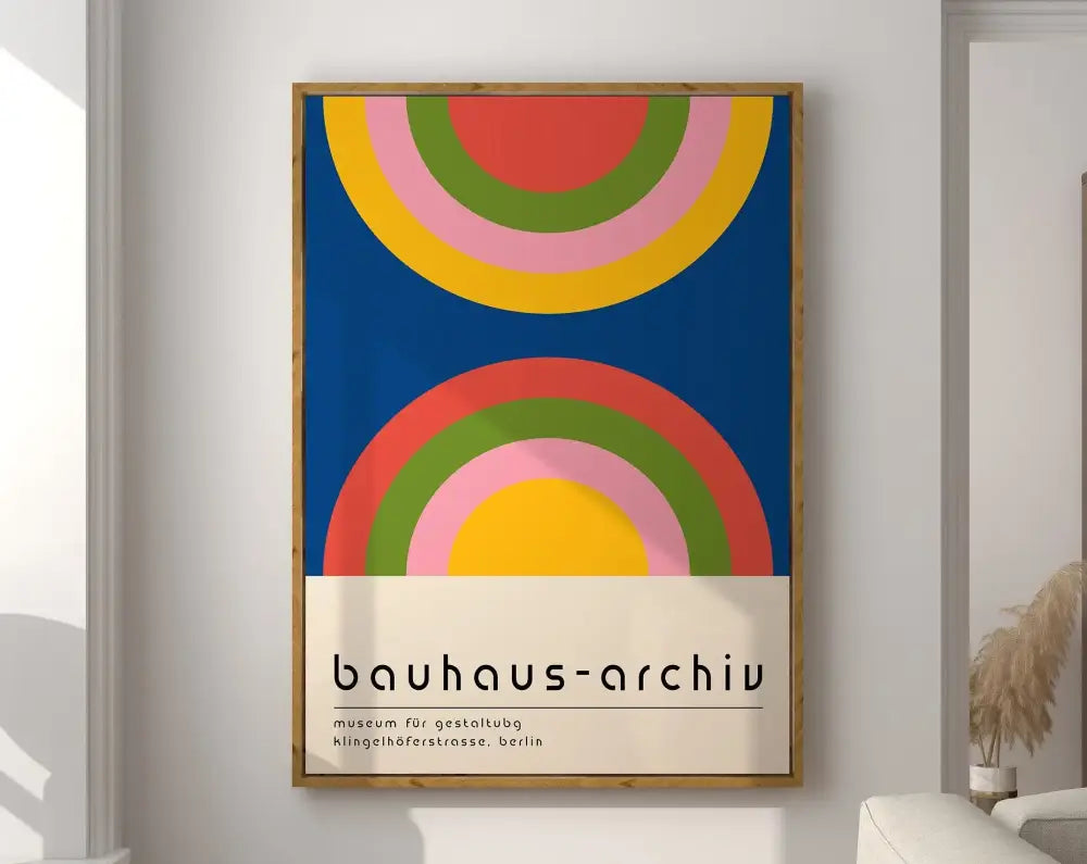 A framed decorbites geometric bauhaus canvas poster with bold red yellow green and pink rainbow arcs on blue background
