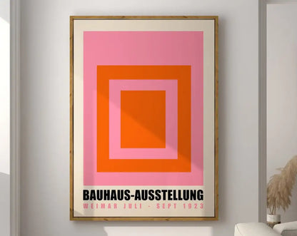 Framed geometric bauhaus canvas poster with concentric pink and orange squares on cream mat for modern home decor