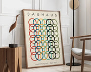 A framed decorbites™ geometric bauhaus canvas poster with overlapping red teal yellow black and olive circles on off-white