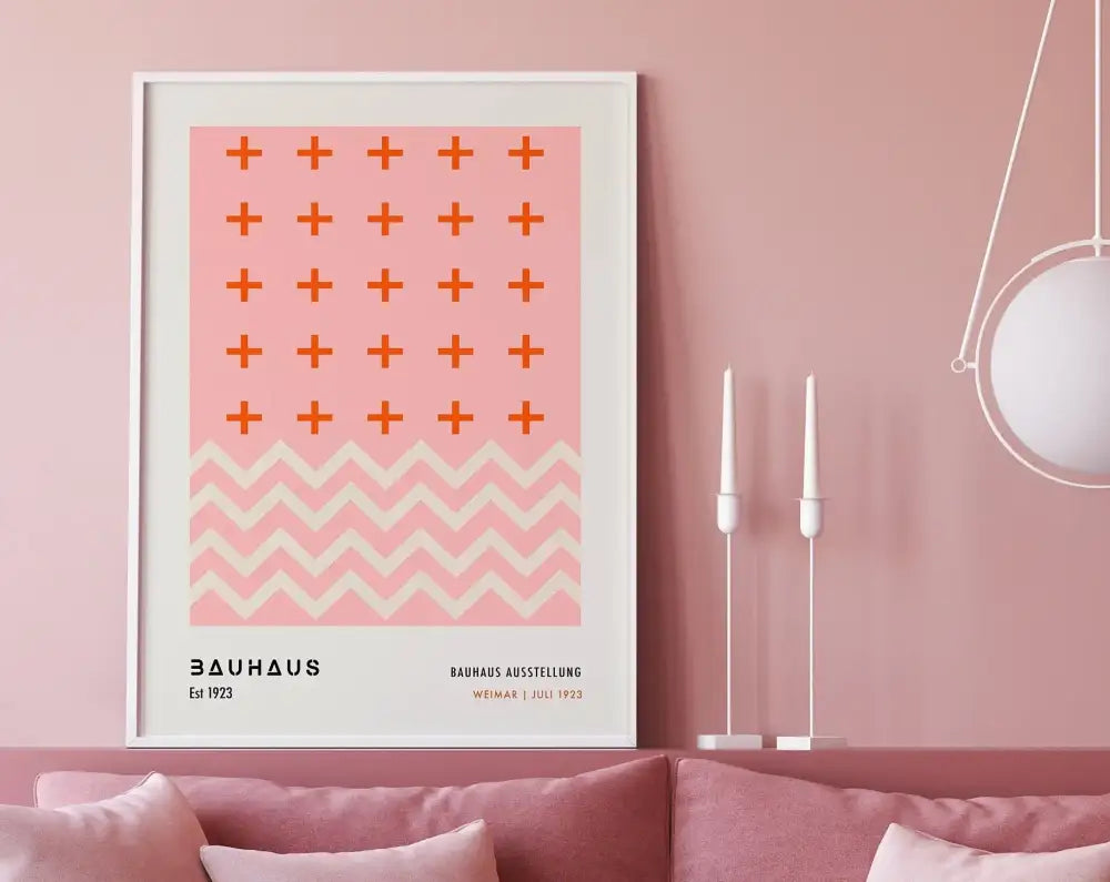 A framed decorbites™ geometric bauhaus canvas poster with a pink background and orange plus signs above a white zigzag pattern