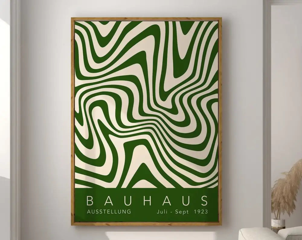 A framed geometric bauhaus canvas print with bold green and cream wavy lines in a light wood frame for modern wall art