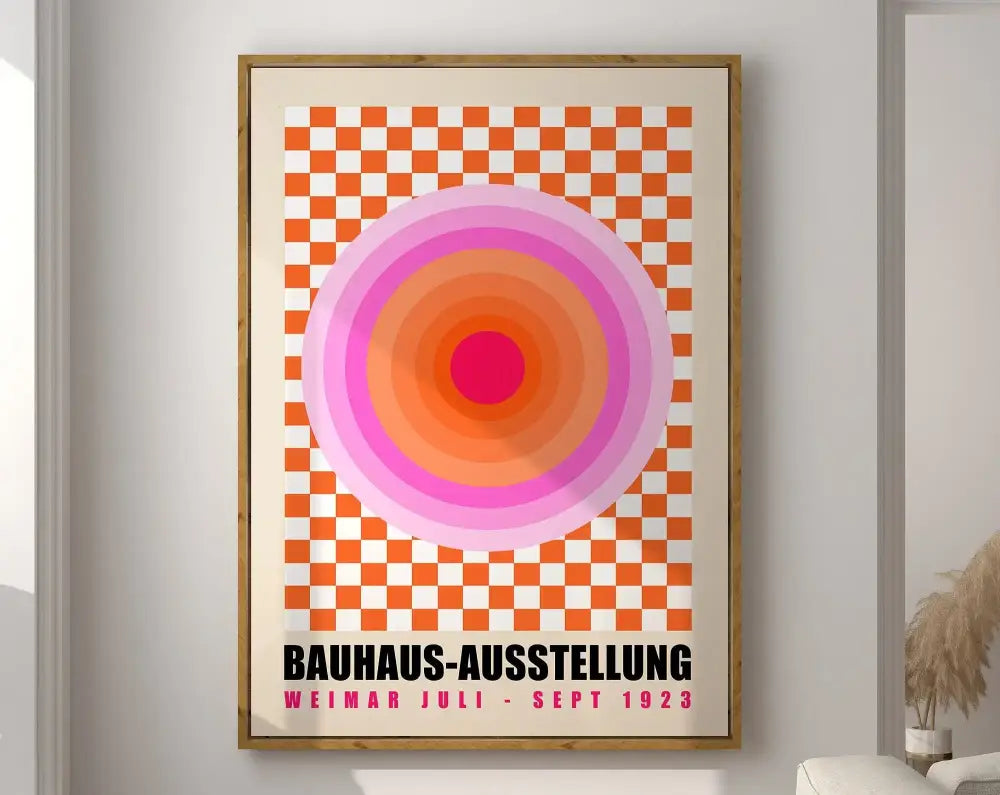 A framed geometric bauhaus canvas print with concentric pink and orange circles on an orange-and-white checkered background