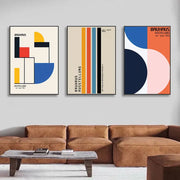 Set of three decorbites™ pop art canvas prints with bold geometric bauhaus shapes in vibrant colors on cream backgrounds