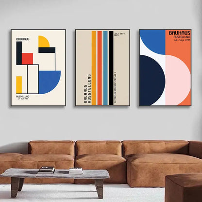 Set of three decorbites™ pop art canvas prints with bold geometric bauhaus shapes in vibrant colors on cream backgrounds