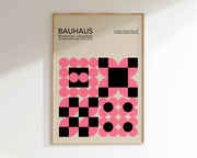 A framed decorbites™ geometric canvas poster featuring pink and black circles in a bauhaus style design