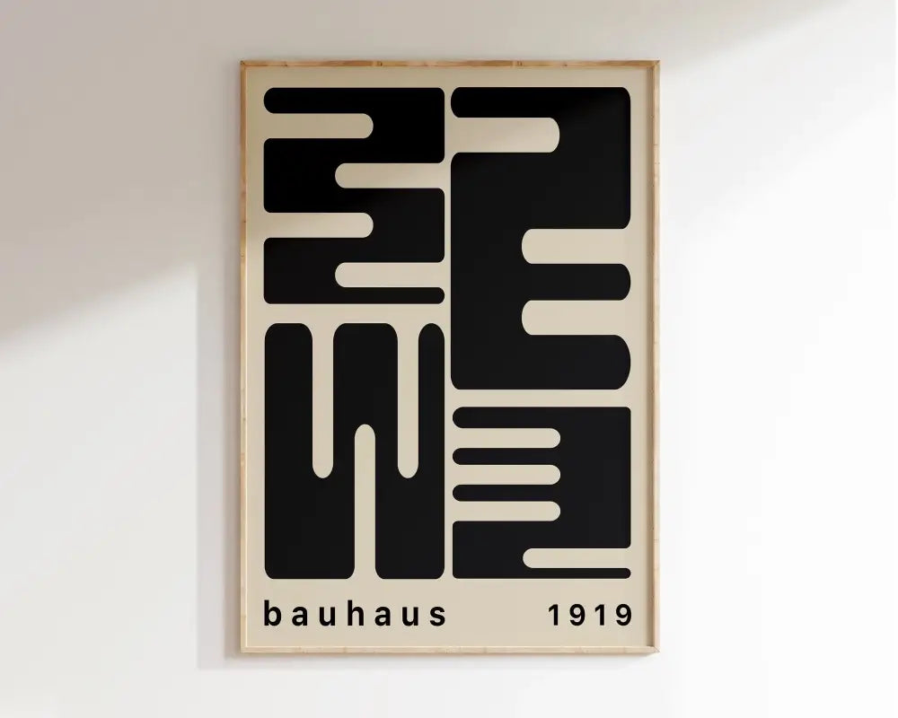 A minimalist bauhaus 1919 mid century wall art geometric canvas print in a light wood frame with bold black typography