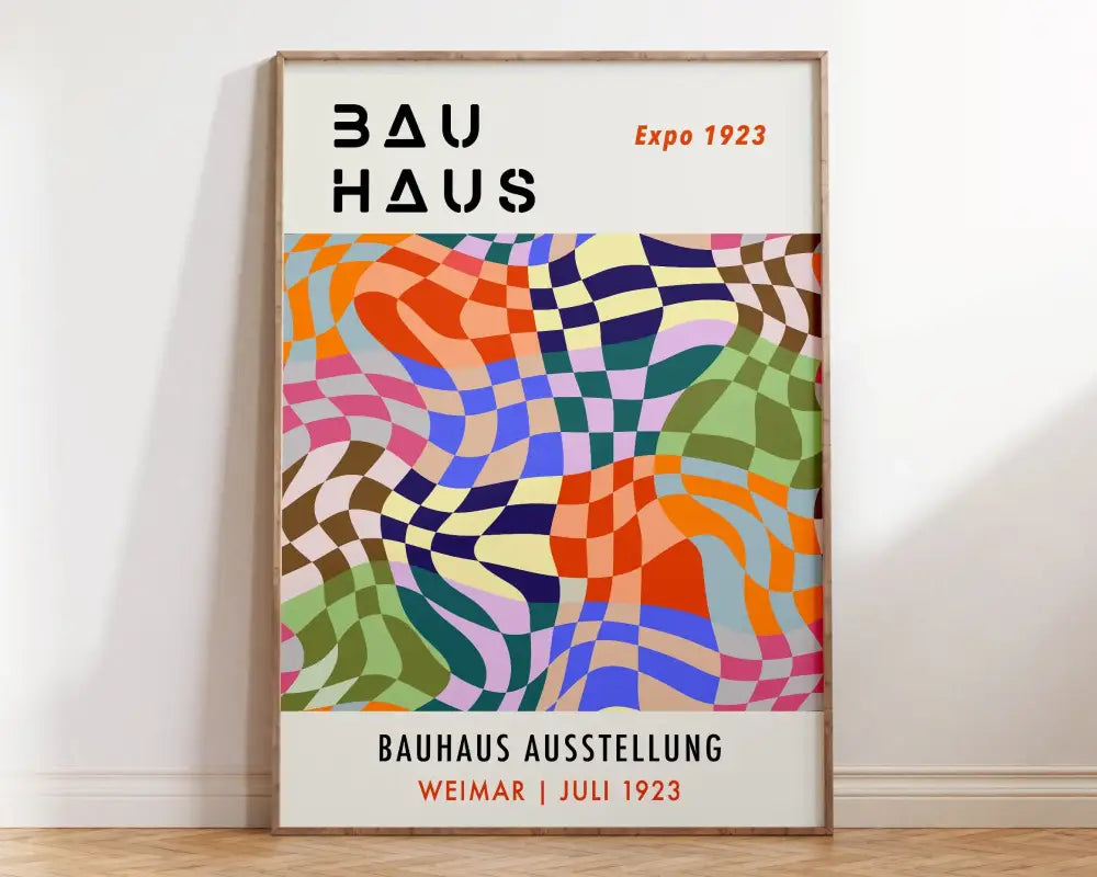 A vibrant mid century bauhaus canvas wall art with bold black and orange text framed in light wood for home decor
