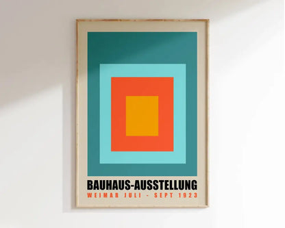 A framed decorbites™ geometric mid century canvas wall art with concentric teal, light blue, orange, and yellow squares