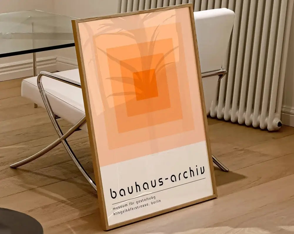 Minimalist geometric modernist canvas poster with concentric orange squares palm leaf silhouette and bauhaus-archiv text