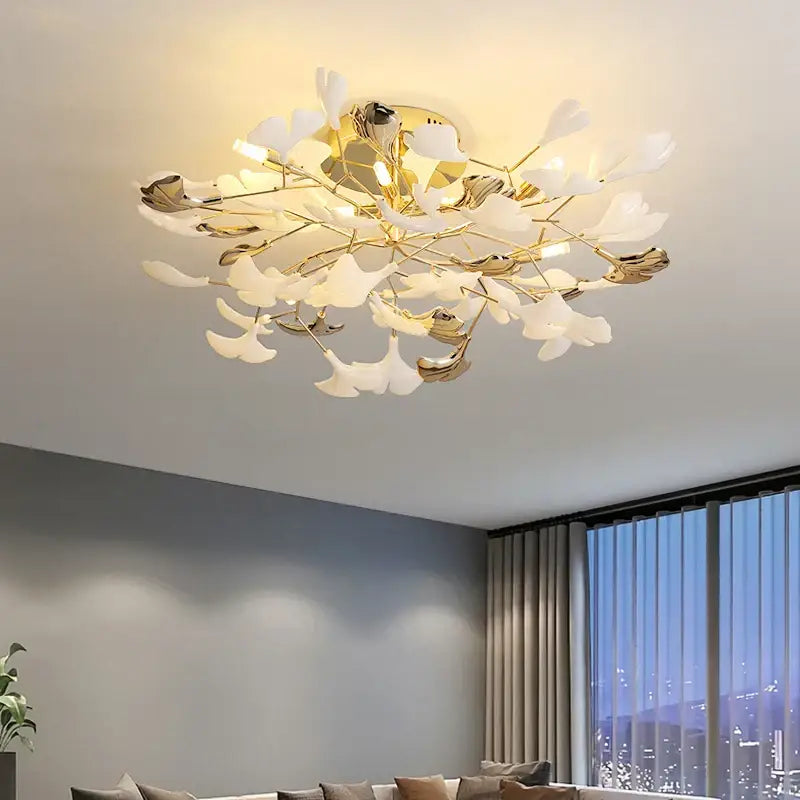 Gold-toned ceiling light fixture with white petal shades in a branching floral design for decorbites ginkgo leaf bedroom