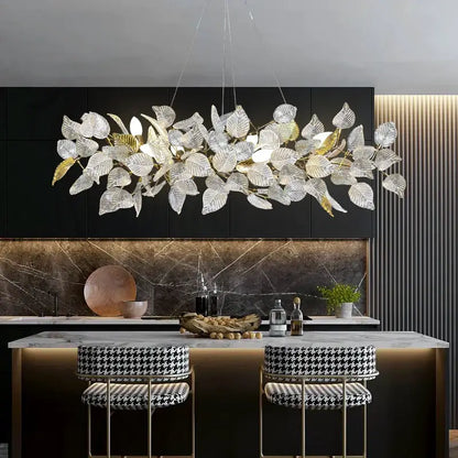 Elegant decorbites ginkgo leaf crystal chandelier with clear and gold-toned leaves above kitchen island