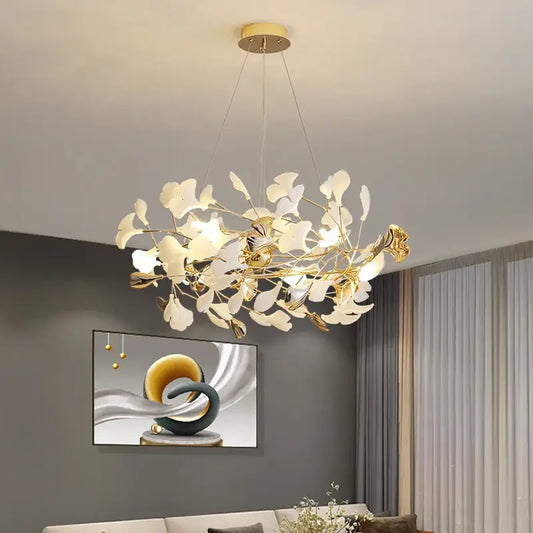 Gold-toned decorbites ginkgo leaf decor chandelier with delicate white glass leaves and modern branching design for living room