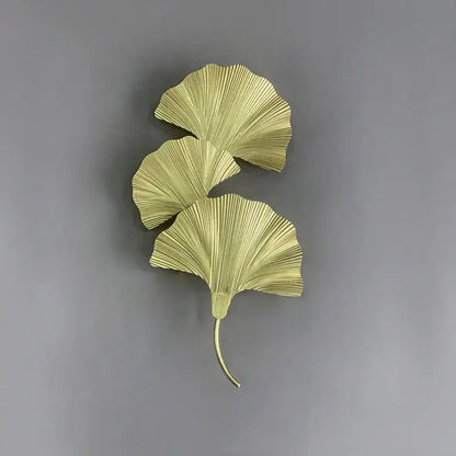 Gold-colored metallic ginkgo leaf wall lamp with three fan-shaped leaves by decorbites for hotel bedroom and corridor
