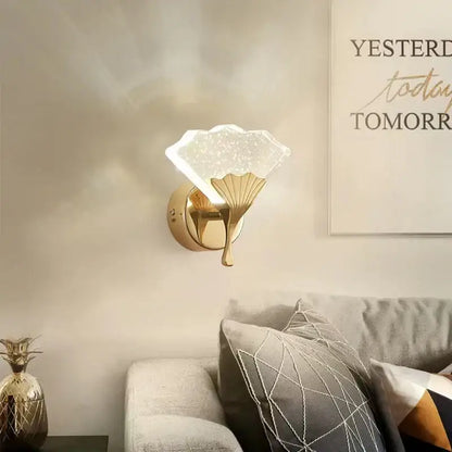 Gold-finished decorbites ginkgo leaf wall lights with a translucent starry glass shade shaped like an open fan