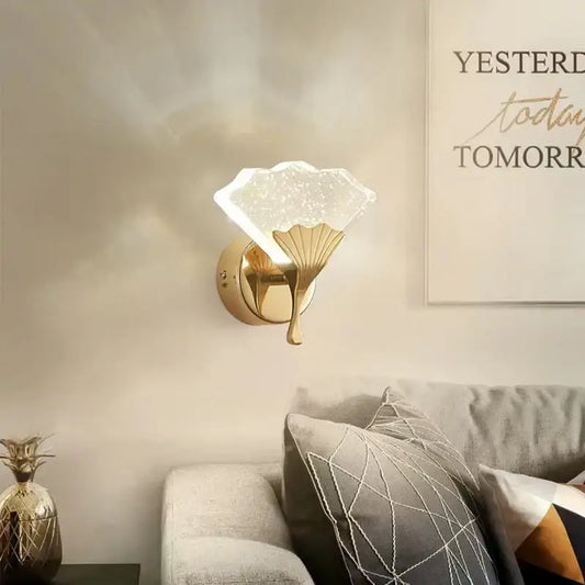 Gold-finished decorbites ginkgo leaf wall lights with a translucent starry glass shade shaped like an open fan