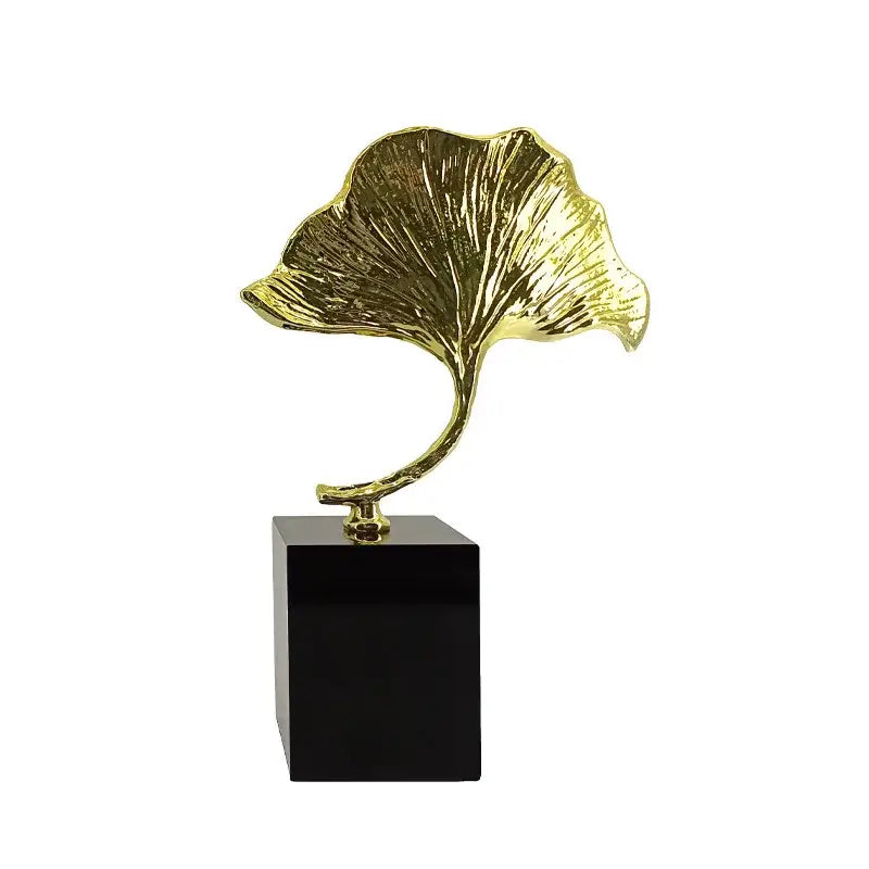 DecorBites ginkgo leaf metal sculpture in golden finish mounted on sleek black base for elegant home decor accent