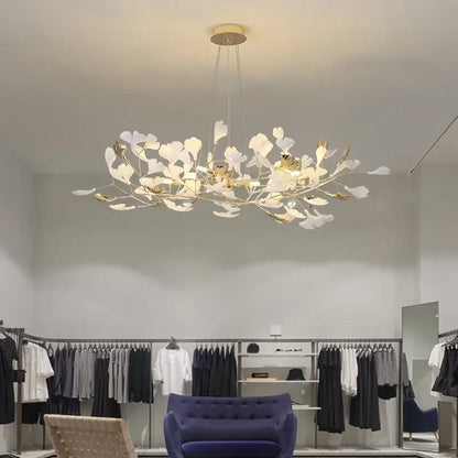 A modern pendant chandelier with white and gold ginkgo leaf accents from decorbites ginkgo leaf collection
