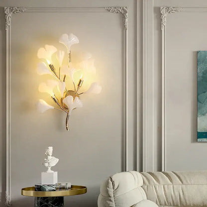 Elegant gold-toned decorbites ginkgo leaf wall lamp with translucent white glass leaves for modern luxury decor