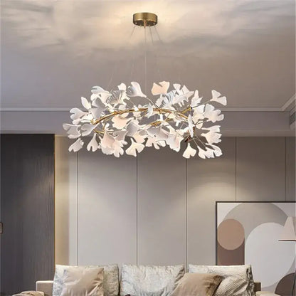 A modern white ginkgo leaves chandelier with gold-toned frame and hanging wires by decorbites ginkgo for luxury decor