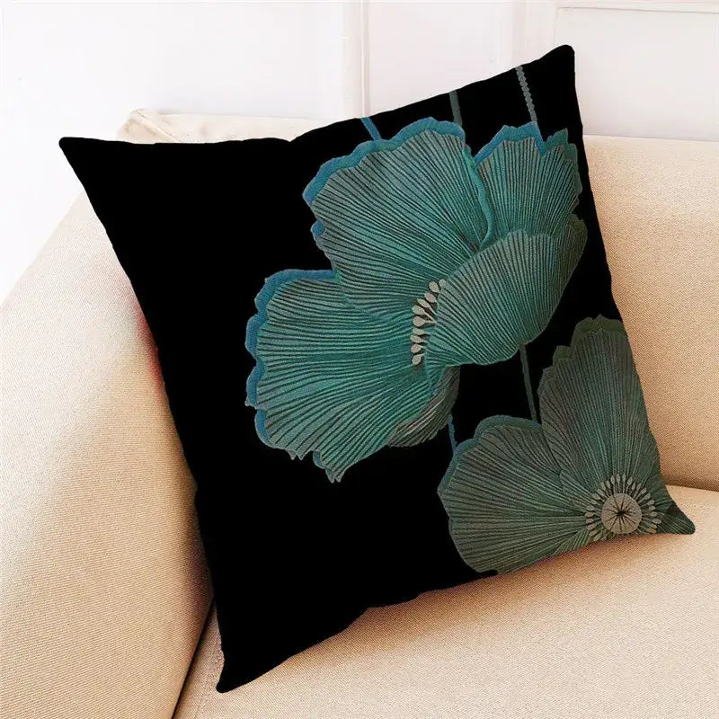 Black cushion cover featuring embroidered teal poppies with detailed petal textures by decorbites ginkgo leaves linen collection