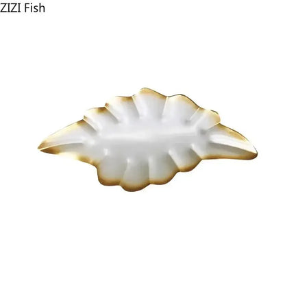 White ceramic dish with gold-trimmed leaf-shaped edges for decorbites ginkgo leaves wall decor accents