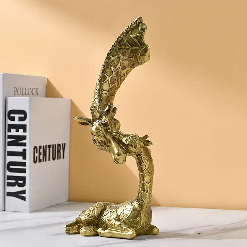 Golden giraffe head sculpture by decorbites features intricate textured resin skin and a gracefully arched reclining neck