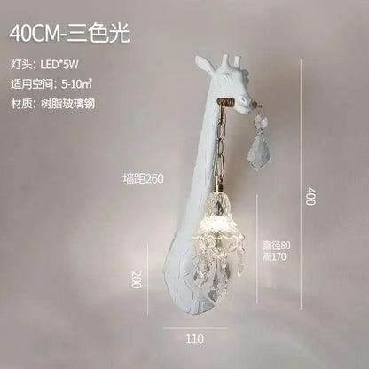 White giraffe-shaped resin wall lamp with crystal chandelier pendant and brass accents for cute room decor