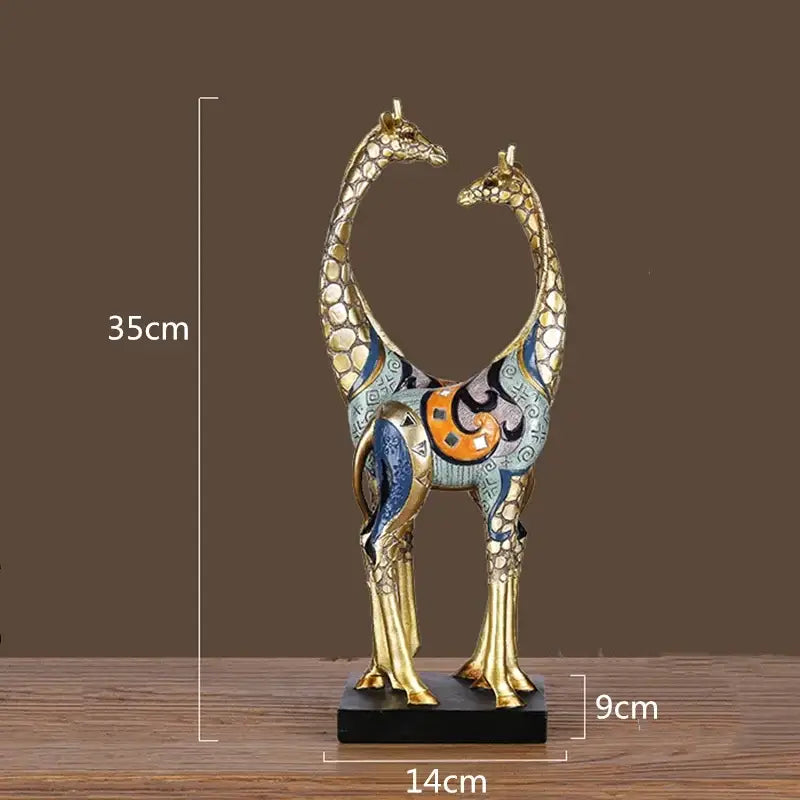 Decorbites giraffe mother and child painted sculpture with gold-toned bodies and intricate blue orange black designs on black base