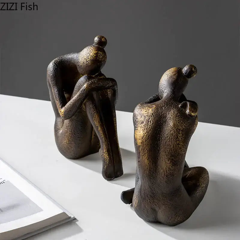 Two abstract bronze-toned resin decorbites girl statue bookends with textured surfaces for desk or bookcase decor