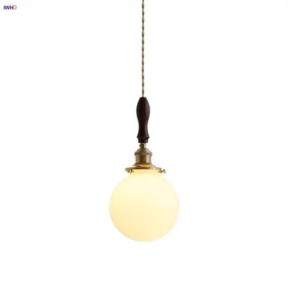 Warm-toned spherical glass pendant lamp with dark walnut wood handle and brass accents decorbites glabe led pendant