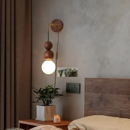 DecorBites glass and wood adjustable wall light with brass curved arm and glowing globe bulb for living room and bedroom