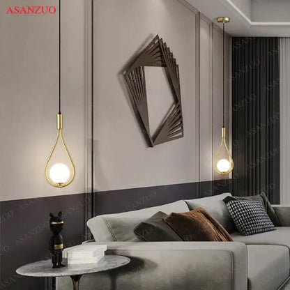 Gold-toned teardrop-shaped decorbites glass ball brass pendant light with sleek modern design for nordic bedroom decor